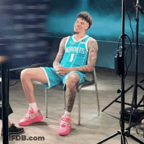 Hornets Player Sitting With Legs Crossed GIF