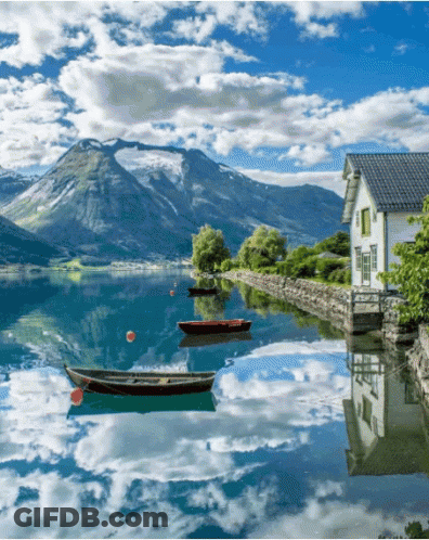 House On Lake Shore With Boats GIF
