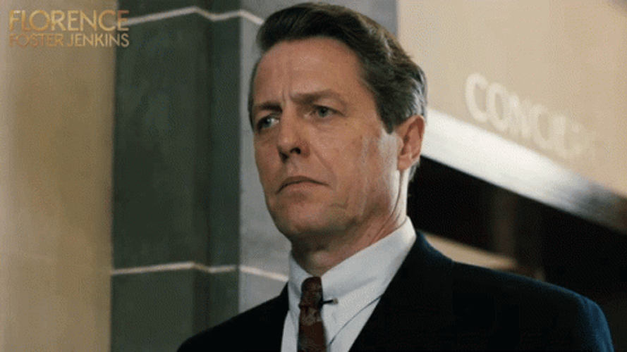 Hugh Grant Looking Around Thinking GIF