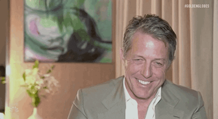 Hugh Grant Smiling Awkwardly GIF