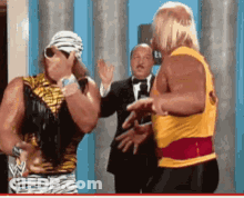 Hulk Hogan And A Man In A Tuxedo Are Having A Conversation GIF