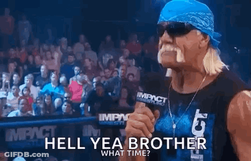 Hulk Hogan Is Holding A Microphone In Front Of A Crowd And Talking Into It . GIF