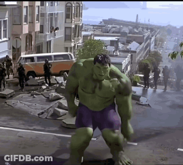 Hulk In Purple Shorts Walking Down Street GIF