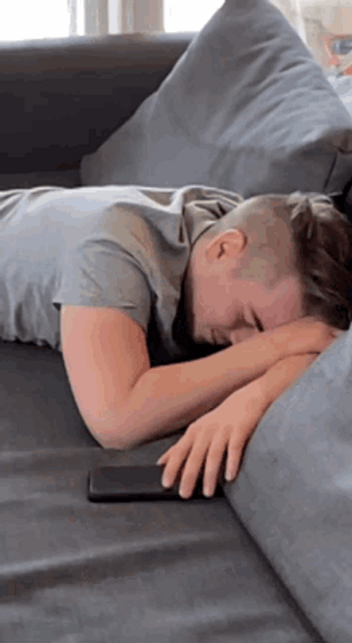 Hungover Guy Feeling Sick On Sofa GIF