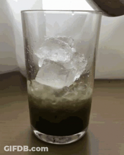 Ice Cubes Pouring Into Green Drink GIF