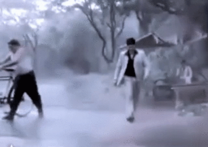 Indian Guy Playing In Monsoon Water GIF