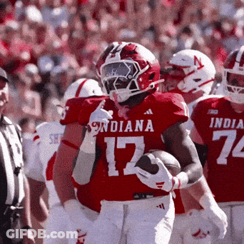 Indiana Football Player Number 17 Holding A Football GIF