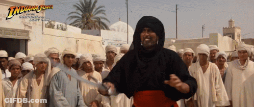 Indiana Jones Poster Man Holding Sword In Front Of Crowd GIF