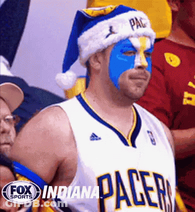 Indiana Pacers Fan In Santa Hat And Blue Face Paint GIF