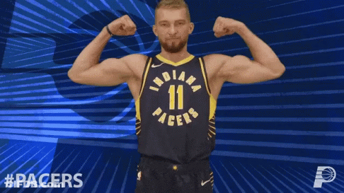 Indiana Pacers Player Flexing Muscles On Blue Background GIF