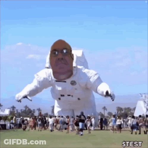 Inflatable Astronaut With Man's Face Flying GIF