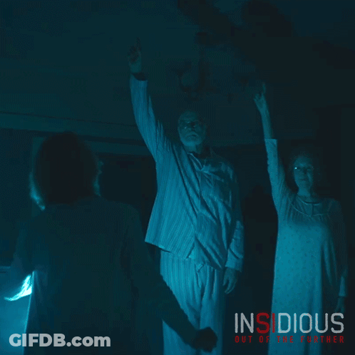 Insidious Out Of The Further Poster Man And Woman In Dark Room GIF