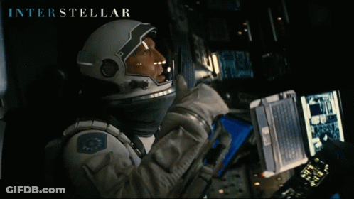 Interstellar Astronaut Looking At Laptop GIF