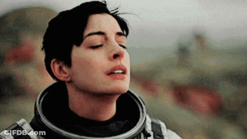 Interstellar Man In Space Suit Looking At Laptop GIF