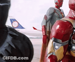 Iron Man And Black Panther Are Standing Next To Each Other In Front Of An Airplane GIF