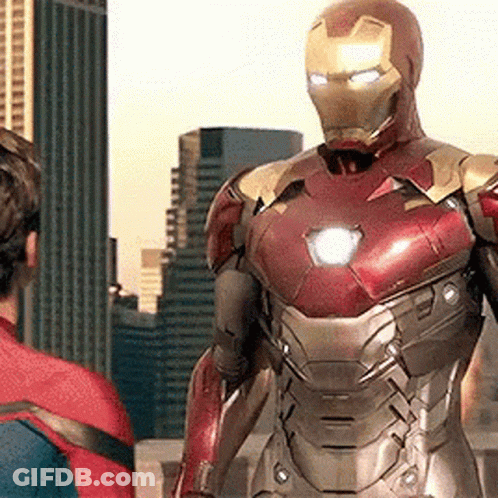 Iron Man Is Standing Next To A Man In A Spiderman Suit . GIF