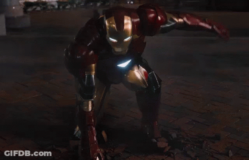 Iron Man Standing In Front Of City At Night GIF