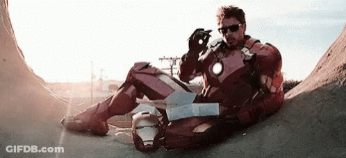 Iron Man Suit Man Next To Man In Black Jacket GIF
