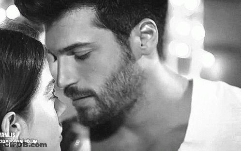 It Is A Black And White Photo Of A Man And Woman Kissing . GIF