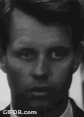 It Is A Black And White Photo Of A Man 'S Face . GIF