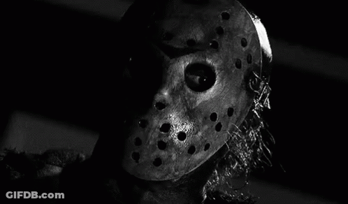 It Is A Black And White Photo Of A Person Wearing A Hockey Mask . GIF