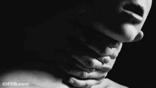 It Is A Black And White Photo Of A Woman Holding Her Neck . GIF