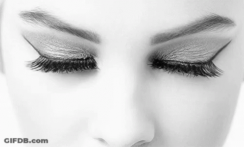 It Is A Black And White Photo Of A Woman 'S Eyes With Long Eyelashes . GIF