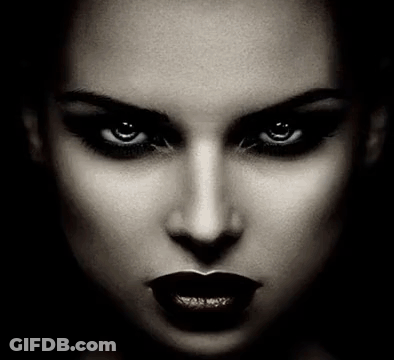 It Is A Black And White Photo Of A Woman 'S Face With Dark Lipstick And Evil Eyes . GIF