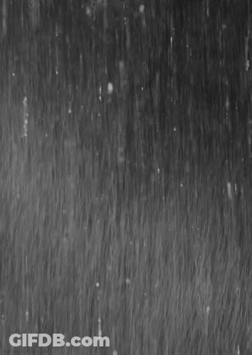 It Is A Black And White Photo Of Rain Falling On A Surface . GIF