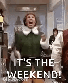 It 'S The Weekend ! A Man In A Green Shirt Is Standing In A Room With His Mouth Open . GIF