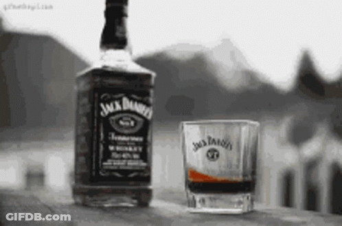 Jack Daniel's Whiskey Next To Shot Glass GIF