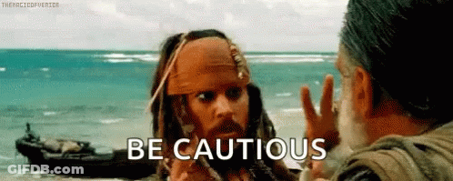 Jack Sparrow From Pirates Of The Caribbean Is Talking To Another Man On The Beach While A Boat Is In The Background . GIF