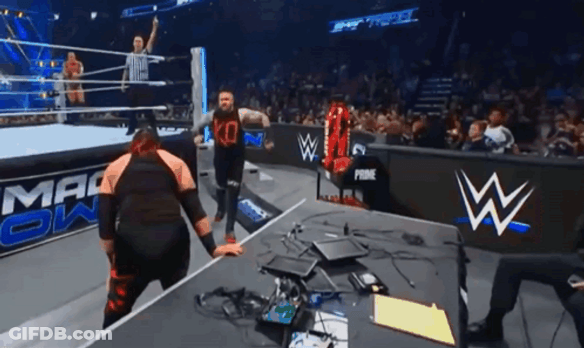 Jacob Fatu Tossing Kevin Owens Onto Table GIF