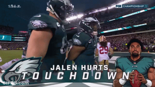 Jalen Hurts Holding Football In Front Of Fox Championship Banner GIF