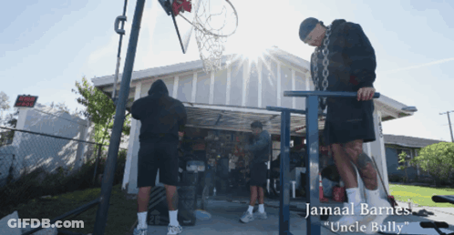 Jamaal Barnes Standing In Front Of Garage With Basketball Hoop GIF