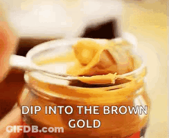 Jar Of Peanut Butter With Spoon Dip Into The Brown Gold GIF