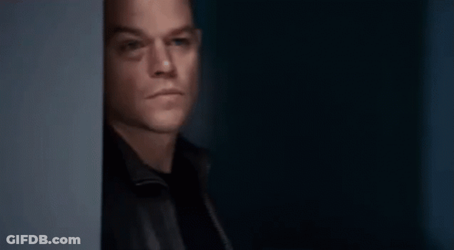 Jason Bourne Hiding Behind Wall GIF