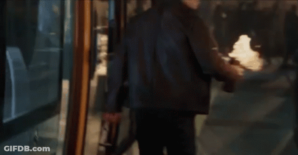 Jason Bourne Tossing A Bottle On Fire GIF