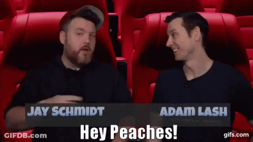 Jay Schmidt And Adam Lash Are Sitting In Red Seats Talking To Each Other GIF