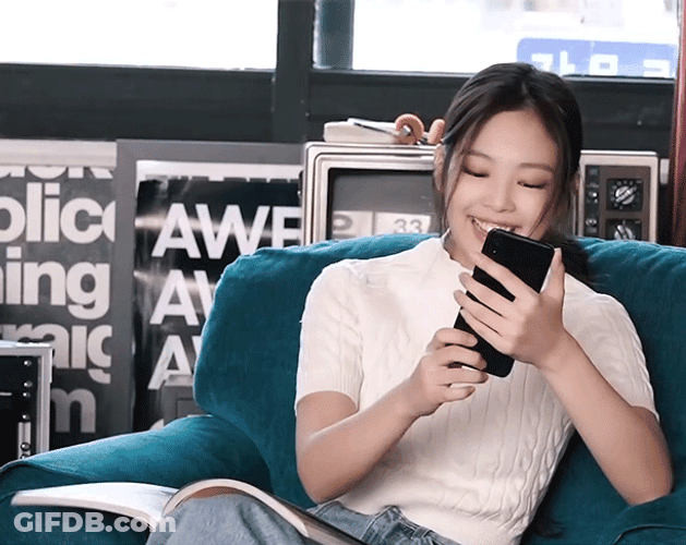 Jennie Laughing While Reading GIF