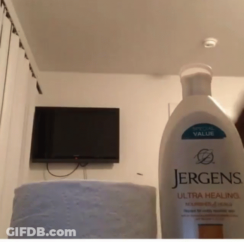 Jergens Ultra Healing Lotion In Front Of TV GIF