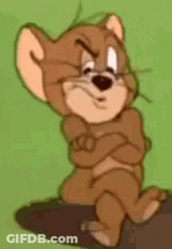 Jerry From Tom And Jerry Is Sitting On A Rock With His Arms Crossed And Looking Angry . GIF