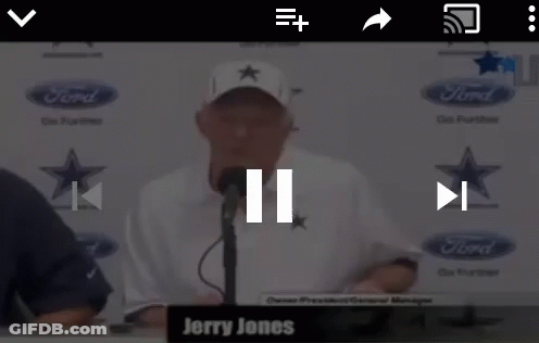 Jerry Jones Is Talking Into A Microphone In Front Of A Ford Logo GIF