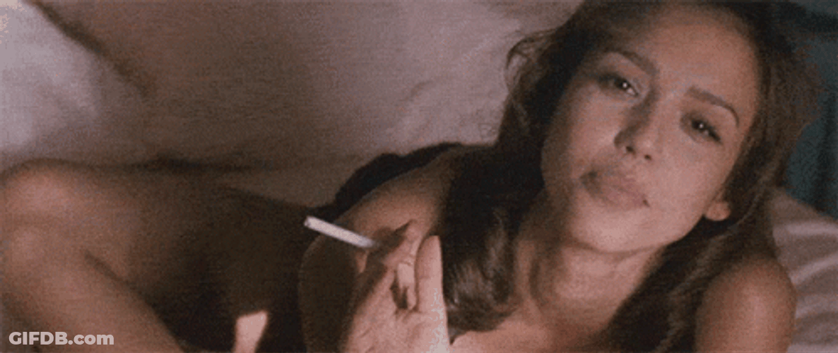 Jessica Alba Holding Cigarette While Lying In Bed GIF