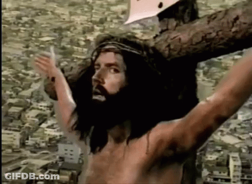 Jesus On Cross With Arms Outstretched Before City GIF