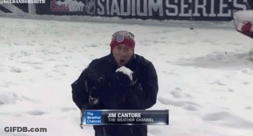 Jim Cantore Is Standing In The Snow Holding A Snowball GIF