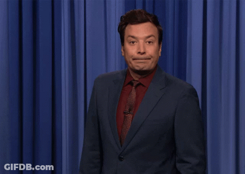 Jimmy Fallon Shocked In Front Of Blue Curtain GIF