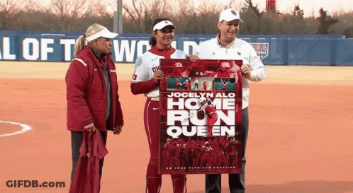 Jocelyn Alo Is The Home Run Queen And Is Holding A Poster GIF