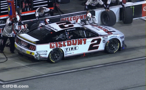 Jockey Standing On Race Car GIF