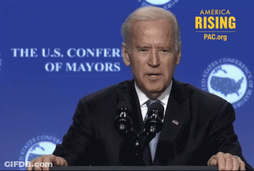 Joe Biden At Podium With U.S. Confer Of Mayors Sign GIF